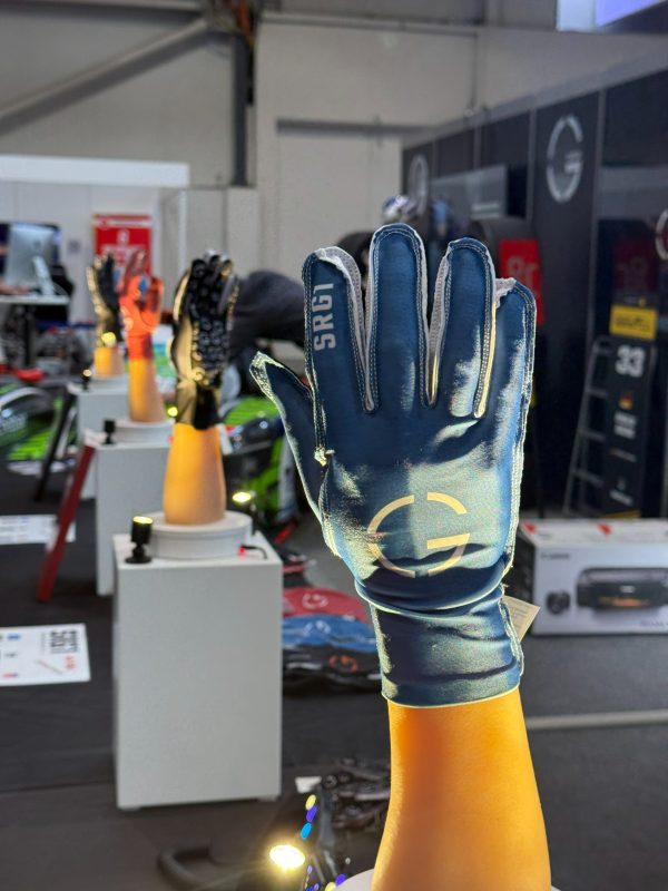 SRG1 sim racing glove in Glacier Blue on a display hand at the GCOM360 booth